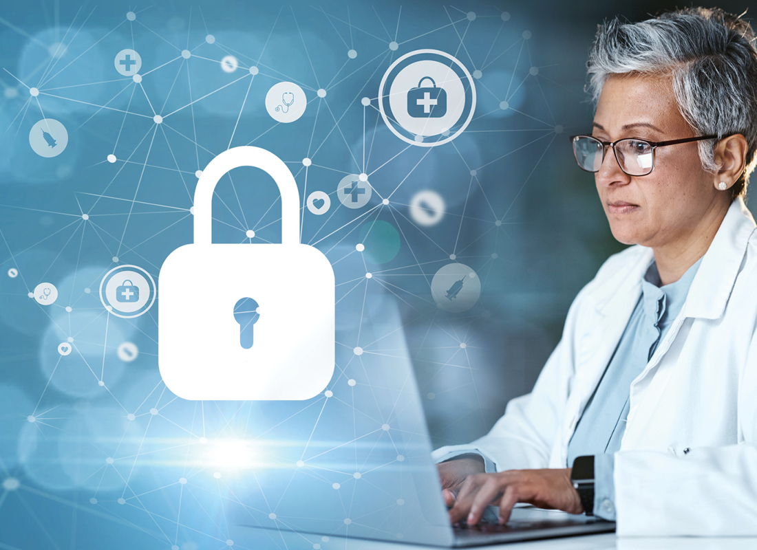 The image of a laboratorian working on a laptop is overlaid with symbols representing cybersecurity and medicine.