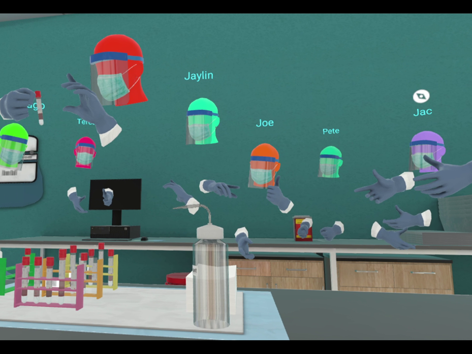 Avatars in PPE work with test tubes at the bench of a virtual laboratory.