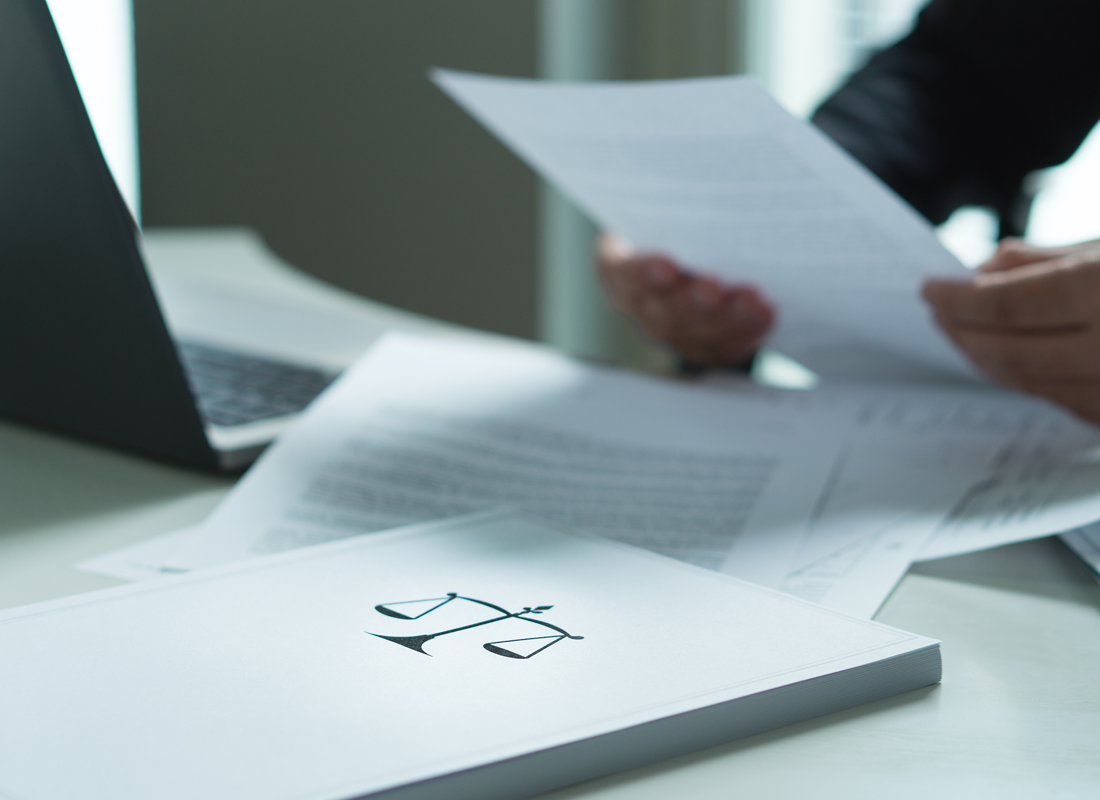 A closeup of someone looking at legal documents at a desk