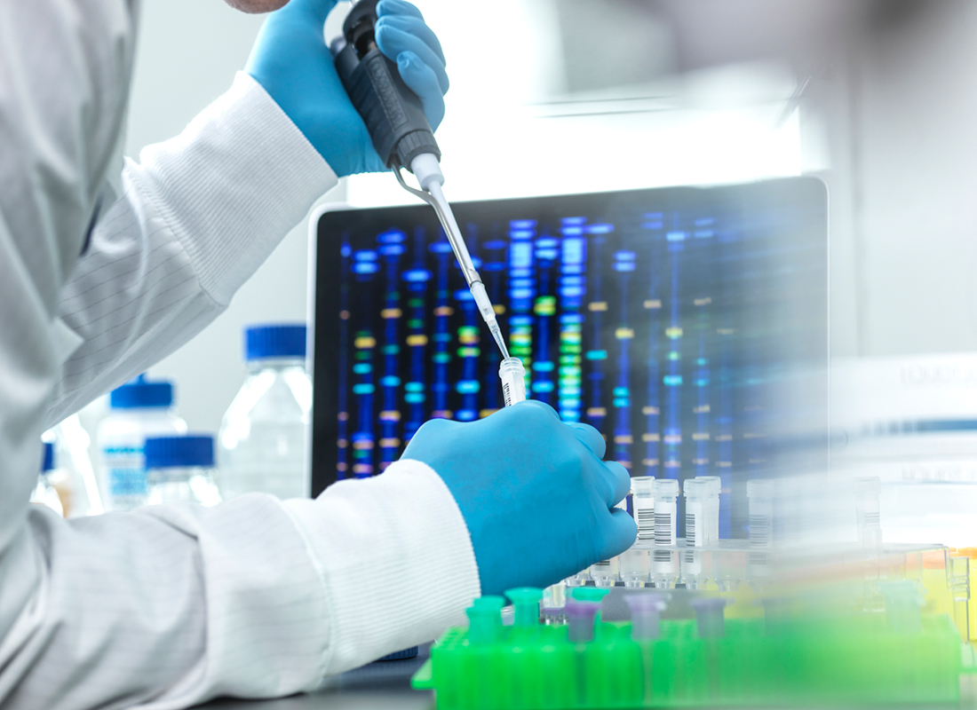 Scientist pipetting sample into a vial for DNA testing.